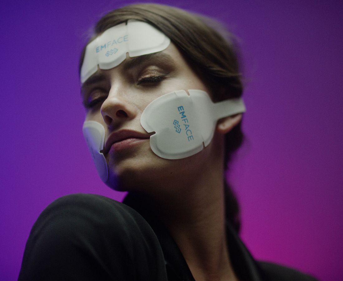 A woman with Emface pads on her face.